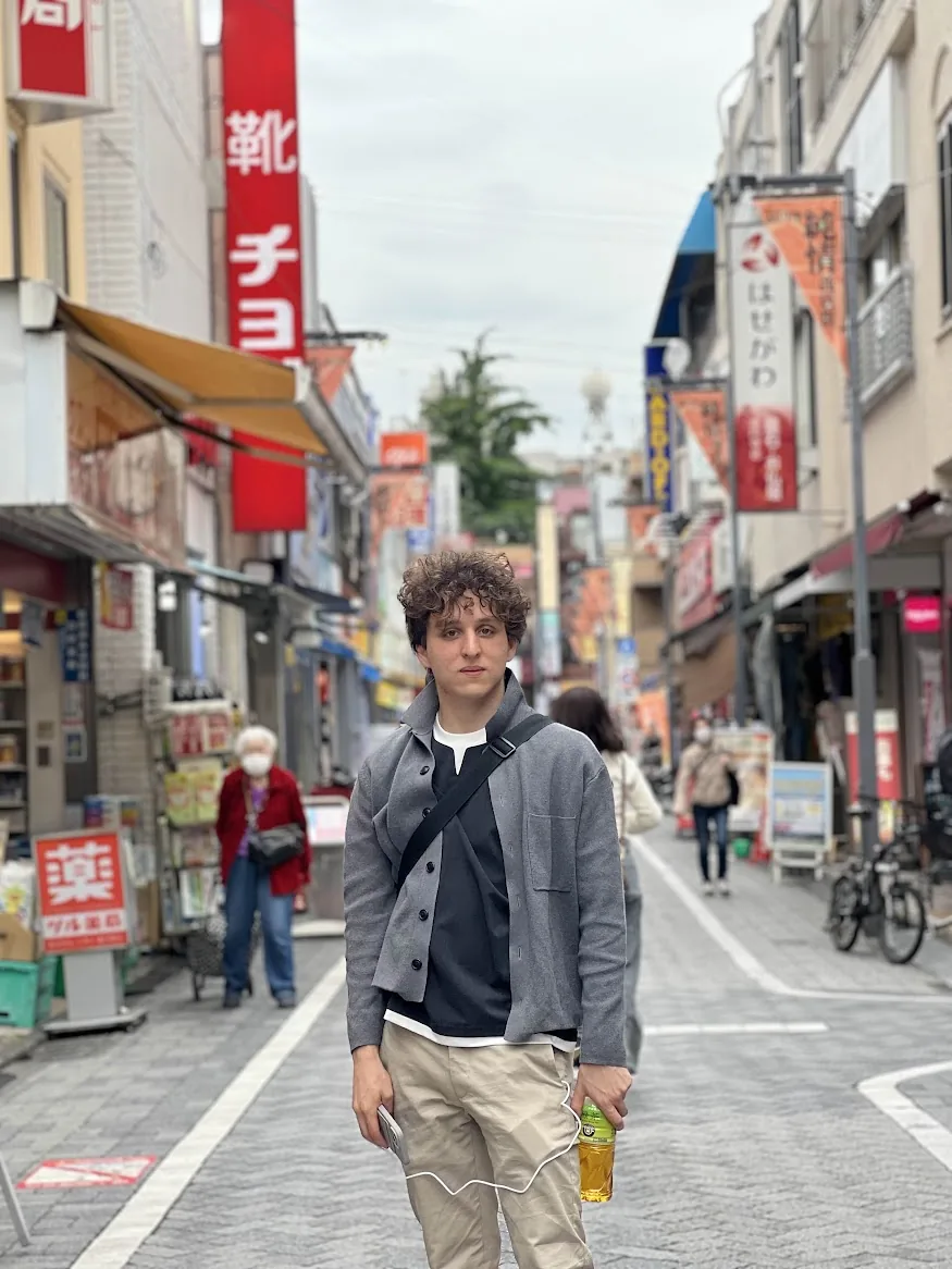 Rome Drori standing in a shopping street in Japan